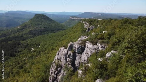 Beautiful aerial view of the steep high cliffs, covered with green forest. Bakhchisaray, Crimea.