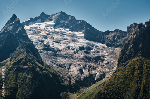 Panorama of high mountains landscape with clouds on sky. Rocks.