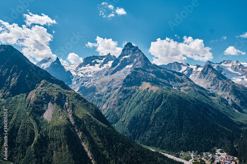 Panorama of high mountains landscape with clouds on sky. Rocks.