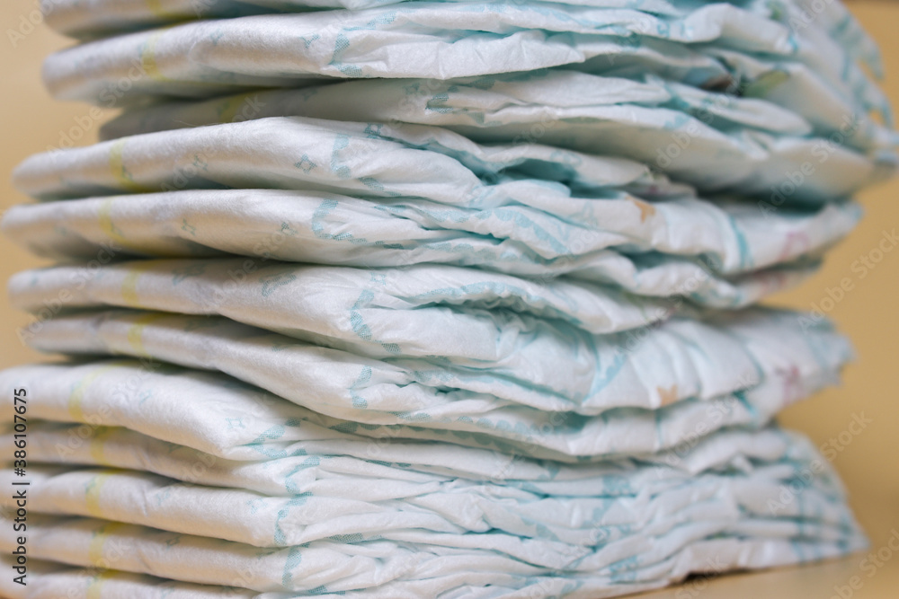 stack of diapers on a light background, baby hygiene products stack of diapers on a light background, baby hygiene products