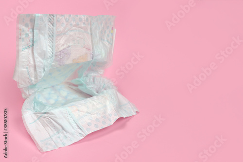 Fototapeta Naklejka Na Ścianę i Meble -  new clean diaper on a light background, baby hygiene products. Copy space for text