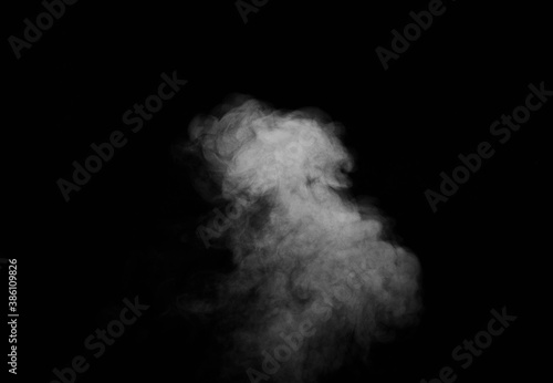 White smoke on black background. Figured smoke on a dark background. Abstract background, design element