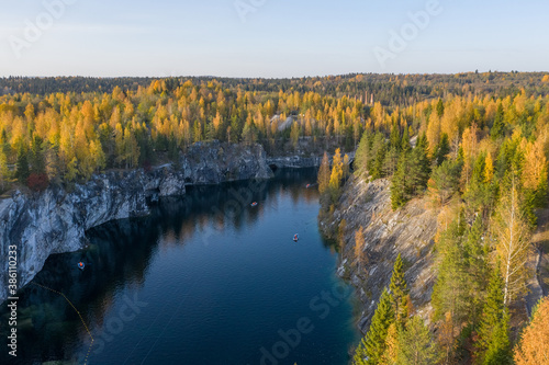 Fototapeta Naklejka Na Ścianę i Meble -  Autumn view from a drone to a quarry in the Ruskeala mountain park. A tourist place in Karelia. Typical nature of the Russian north.