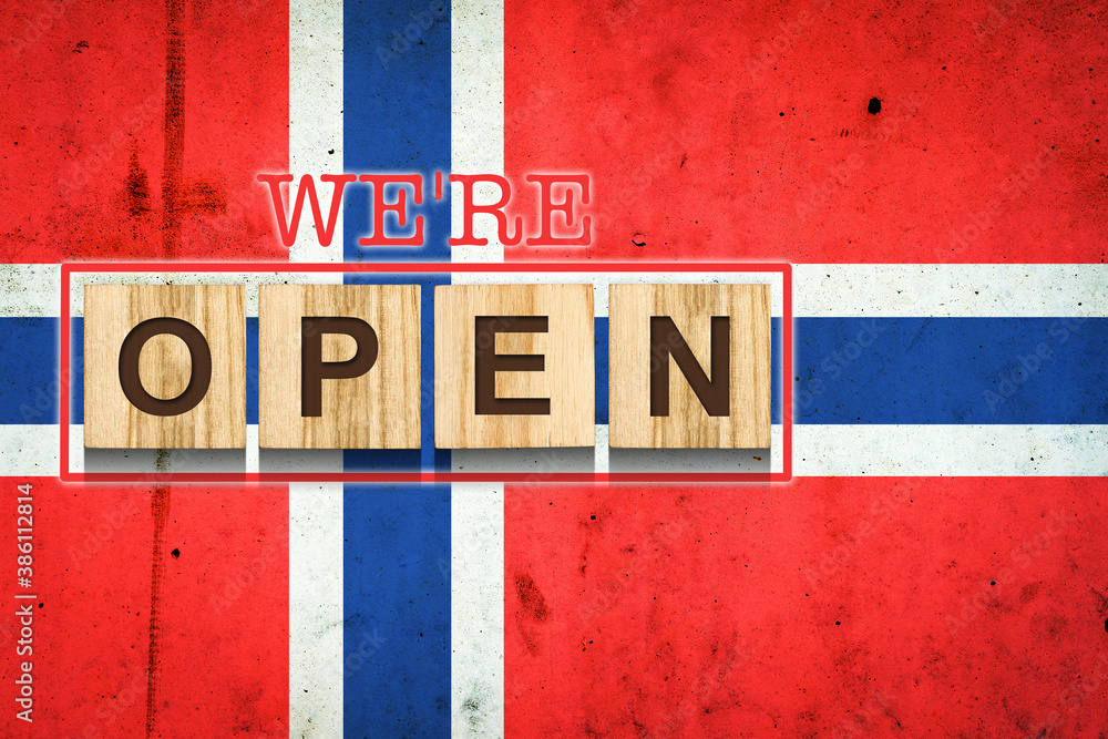 We are open. The inscription on wooden blocks against the background of the flag of Norway. Business. Travel.