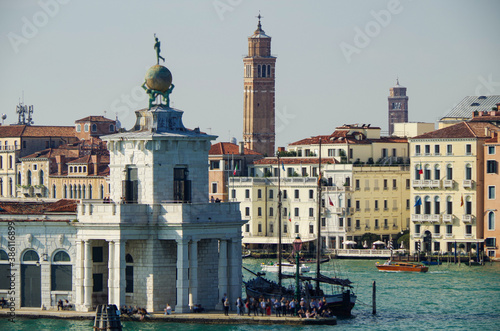 Panoramic scenic view of Venice Venezia skyline with bell towers, old historic buildings palazzi houses, basilica churches and San Marco tower and Doge palace and maritime traffic on Giudecca Canale photo