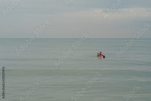 Family swimming in sea in the morning.