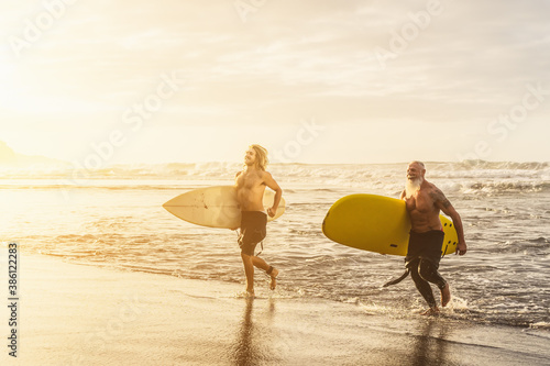 Photography Happy friends with different age surfing together on tropical ocean - Sporty peo