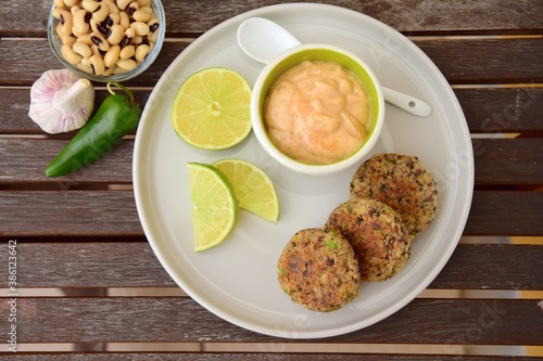 Delicious quinoa jalapeño bean burger patties with chili mayonnaise dip garnish with lime