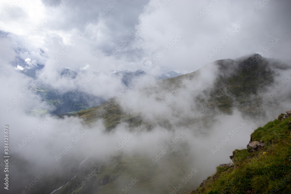 Fog over the Alps in Switzerland on a summer day. 