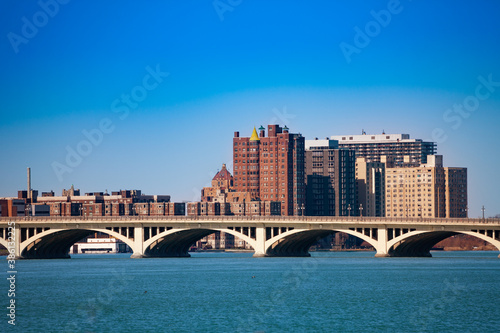 MacArthur bridge over Detroit river on sunny day from sunset point of Belle Isle photo