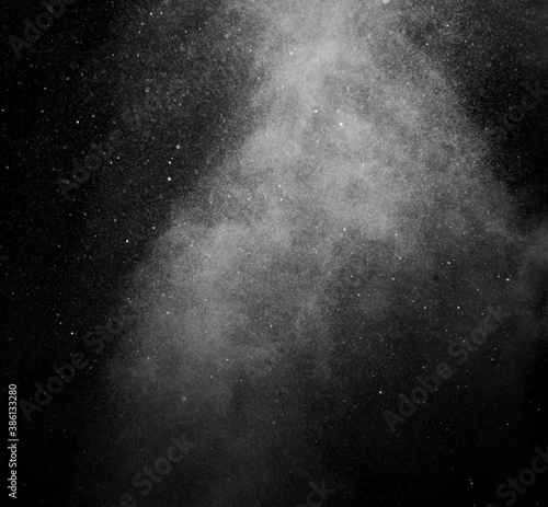 White vapour spray steam from air saturator. Smoke fragments on a black background. Abstract background