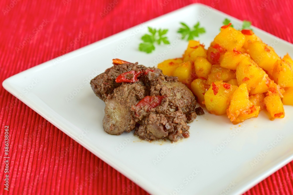 Sambal goreng hati kentang or hot spicy liver and potatoes, Indonesian traditional cuisine served on plate. Typically served during Eid Al-Fitr celebration Sambal goreng hati kentang or hot spicy liver and potatoes, Indonesian traditional cuisine served on plate. Typically served during Eid Al-Fitr celebration