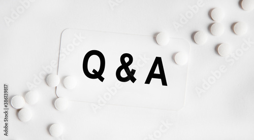Q and A - Questions and Answers - sign through magnifying lens in doctor hands, medical questions concept