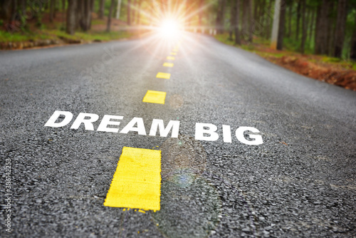 Dream big word on road . Challenge and motivation with success concept and natural background idea
