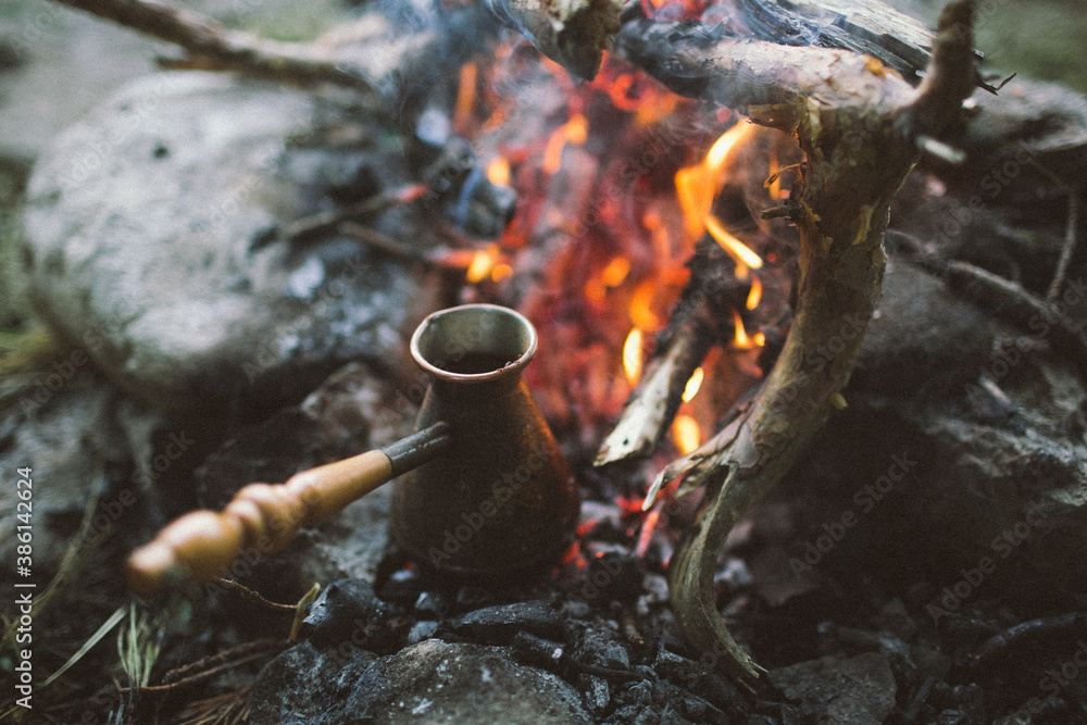 Turk with coffee in the foreground on a campfire in a hike in nature Turk with coffee in the foreground on a campfire in a hike in nature