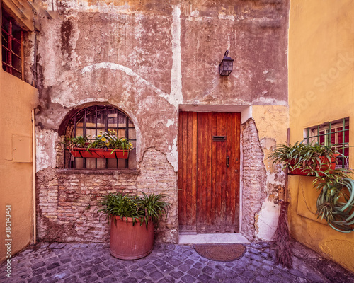 Rome Italy, picturesque house front with natural wood door and window