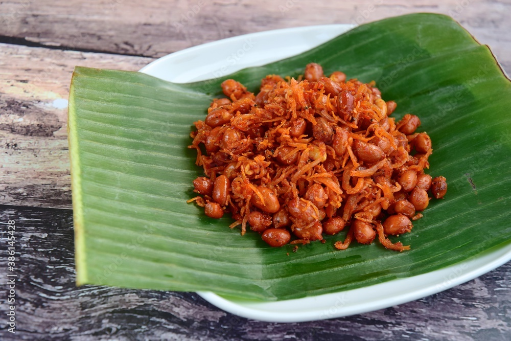 Teri kacang or fried anchovy and peanuts on banana leaf. Traditional ...