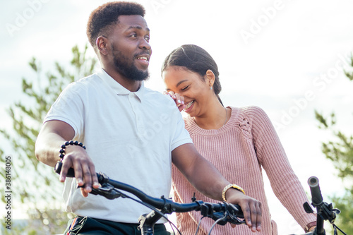 Vietnamese woman and african american man taking a bike for rent