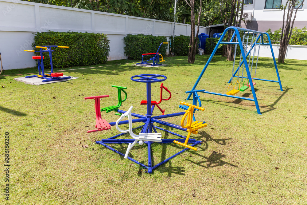 Colorful playground equipment and exercise at grass field outdoor public