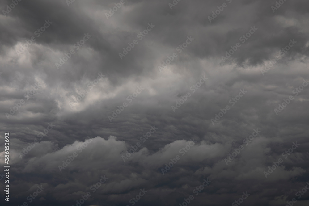 Obraz premium Natural background of dark stormy clouds in gray sky