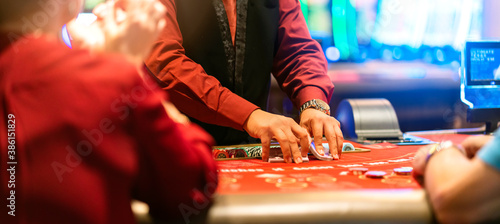 Photography gambling casino concept close up hand worker a croupier is holding playing cards