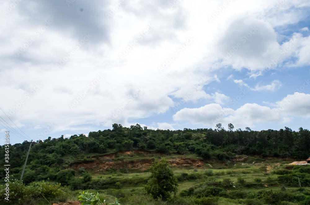 Landslide of mountain soil cut off from hill's bottom area its shining red colour soil hill village area natures are fresh and ever green. Landslide of mountain soil cut off from hill's bottom area its shining red colour soil hill village area natures are fresh and ever green.