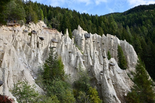 Earth pyramids located in Platten in the municipality of Percha, near the town of Bruneck in South Tirol, Italy, beautiful natural rock monuments in the middle of a forest, a sunny day in autumn