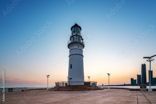 White lighthouse and urban architecture landscape night view