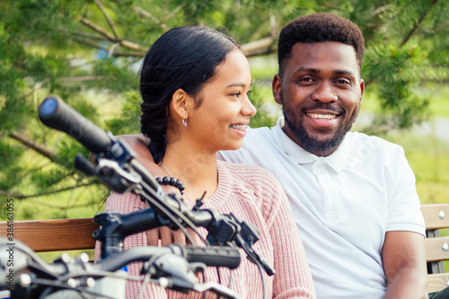 Vietnamese woman and african american man taking a bike for rent photo
