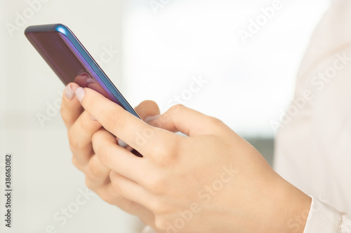 female hands uses the phone at the table, business concept