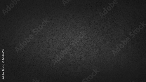 dark black soft grained cement stone tile texture background with space dark gradient corner. abstract vignette black plaster wall background.