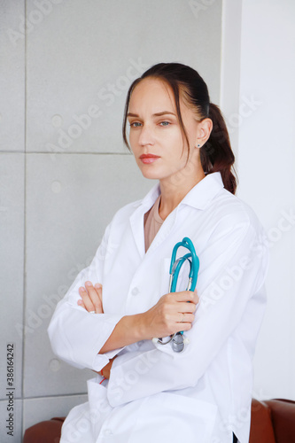 Professional caucasian doctor woman in Gown uniform and hand holding stethoscope is smiling portrait in hospital