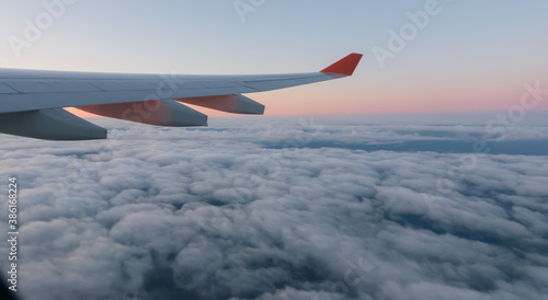 Wing of a airplane at sunrise at an altitude of 11 km.