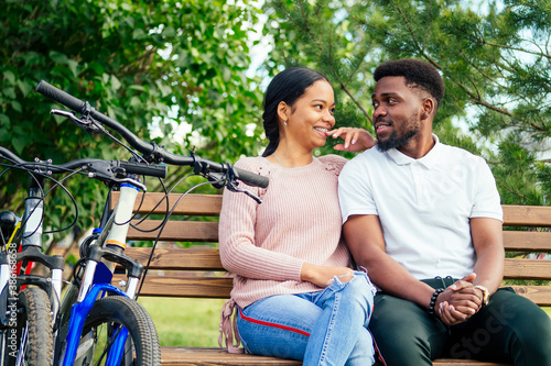 mixed race couple taking a cycle on rent phone app