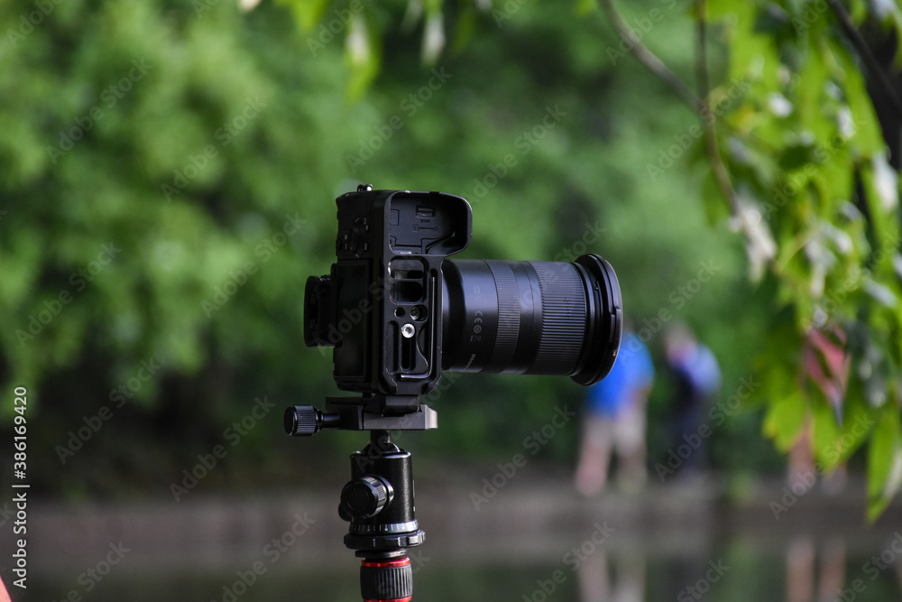 DSLR Camera mounted on a tripod during an outdoor photo shoot in the park