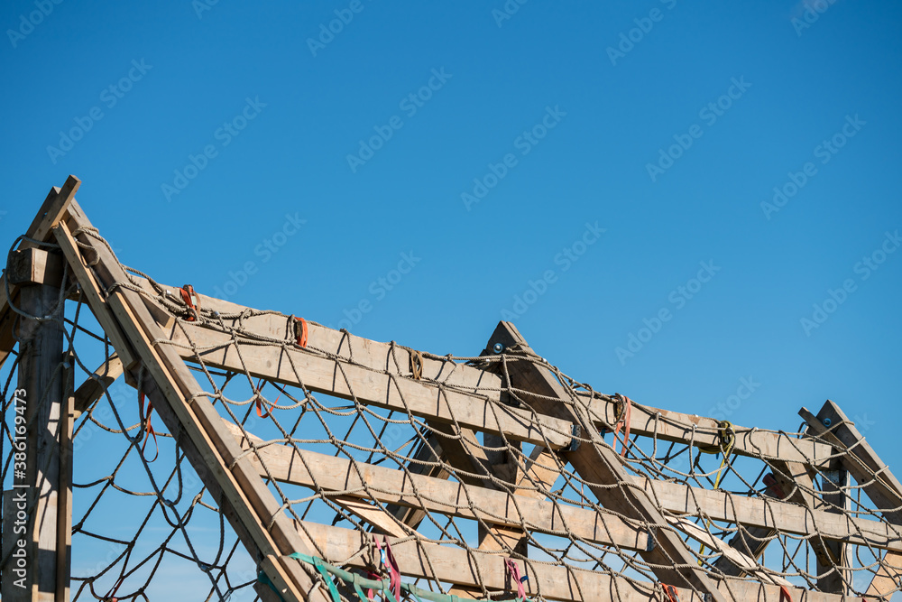 Wooden pyramid obstacle with a net to climb over