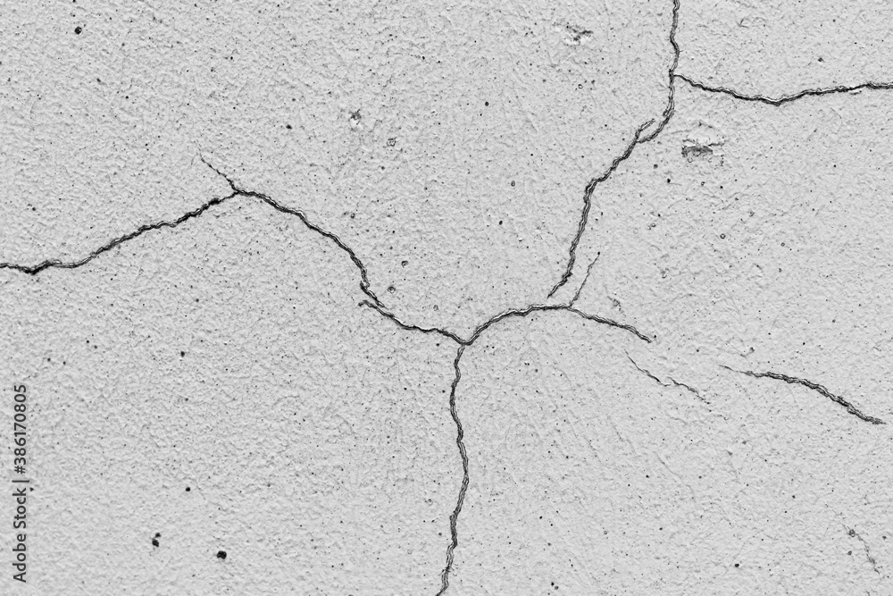 Obraz premium Grey textured plaster as a background.Cracks in the wall