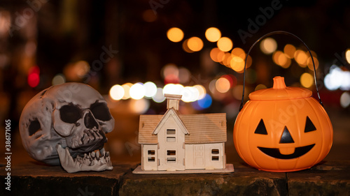 Pumpkin and skull with house designs for Halloween decoration.