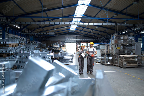 Wallpaper Mural Factory workers in industrial production hall. Torontodigital.ca