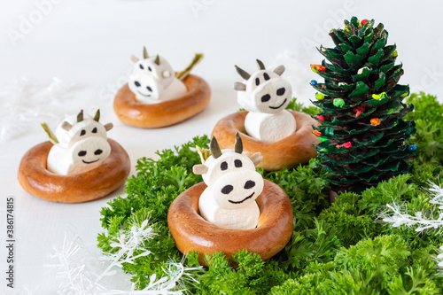 Fototapeta Naklejka Na Ścianę i Meble -  Symbol of the Chinese New Year - cow (bull) from marshmallows. Sweet christmas treat for kids