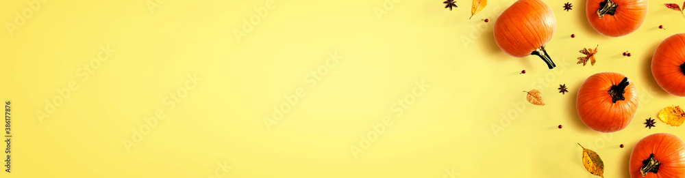 Autumn pumpkins with colorful leaves overhead view - flat lay Autumn pumpkins with colorful leaves overhead view - flat lay