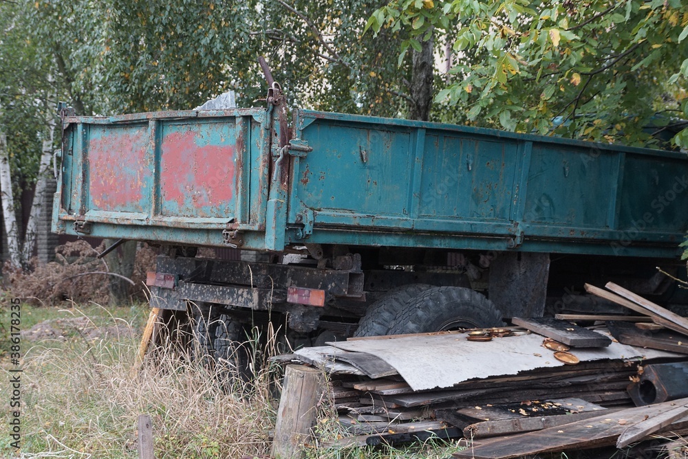 green iron body of an old truck on wheels on the street green iron body of an old truck on wheels on the street