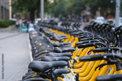 Photography a row of shared bikes in city. perspective and soft focus