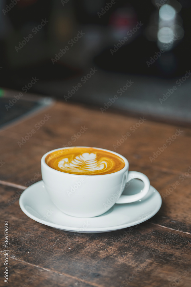 beautiful latte art coffee on wooden table beautiful latte art coffee on wooden table