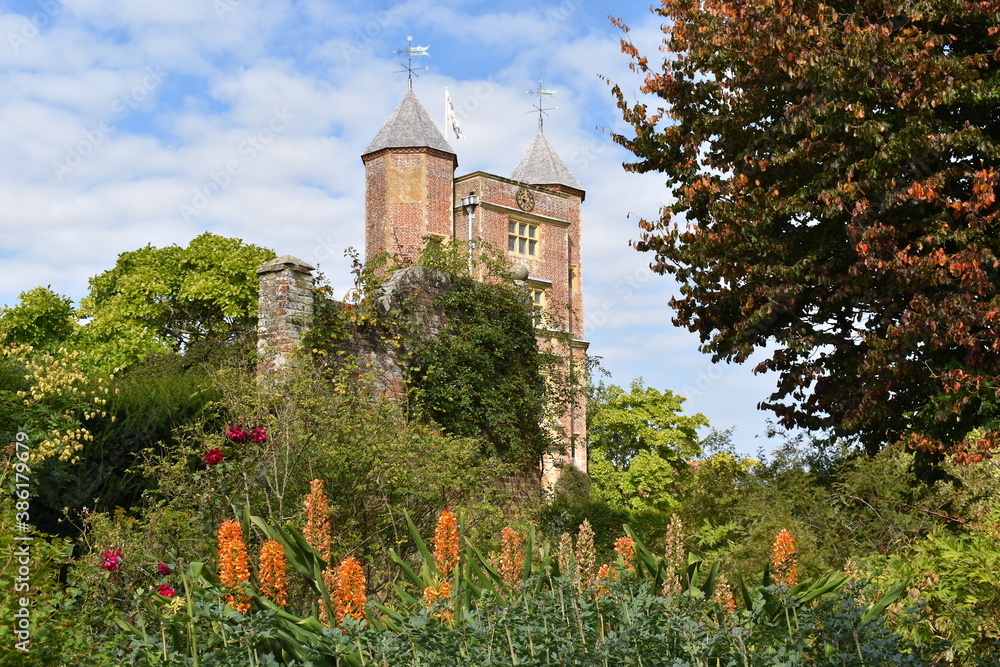 Kent estate surrounded by acres of formal gardens Elizabethan mansion with red brick prospect towers welcoming tourists Castle is type of fortified structure developed in Europe during the Middle Ages