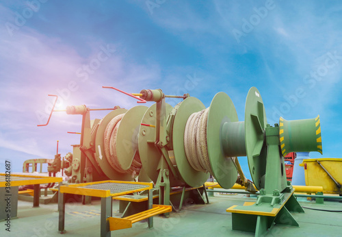 Photography Mooring winch or Mooring windlass and rope in drum on main deck of Oil Tanker ship on blue sky, Mooring winch of large vessel with winch rope in drum