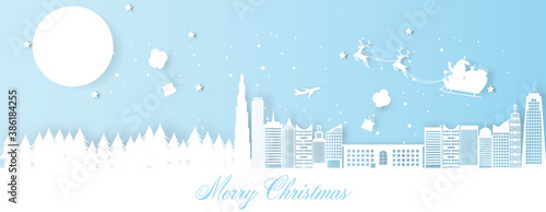 Christmas decoration greeting card with santa claus riding sledge in city.
