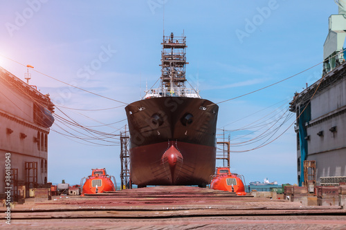Bilde på lerret Cargo ship under repair with scaffolding moored on boat sleeper wood for sandbla
