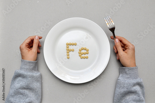 Sign of the trace element "iron" from tablets on a white plate. Iron deficiency in the body
