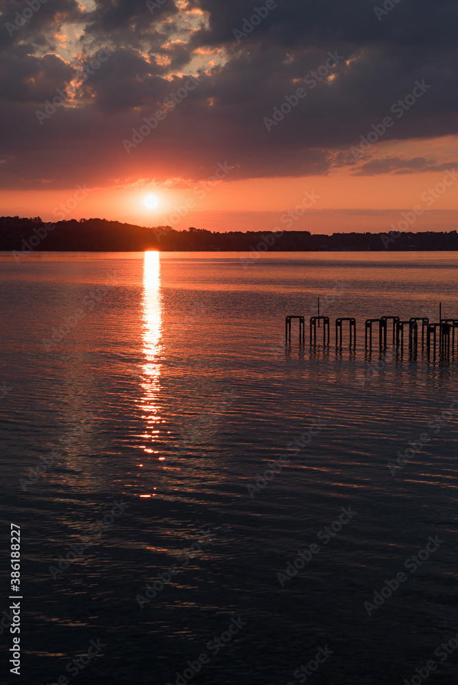sunset at the lake with reflections from the sinking sun sunset at the lake with reflections from the sinking sun